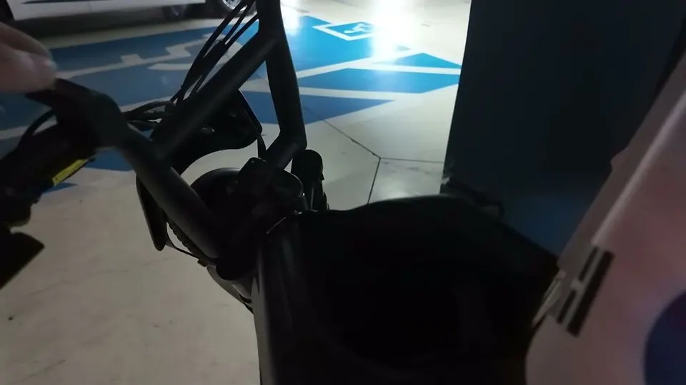 Handlebars of a small two-wheeler in the garage, seen from the rider position