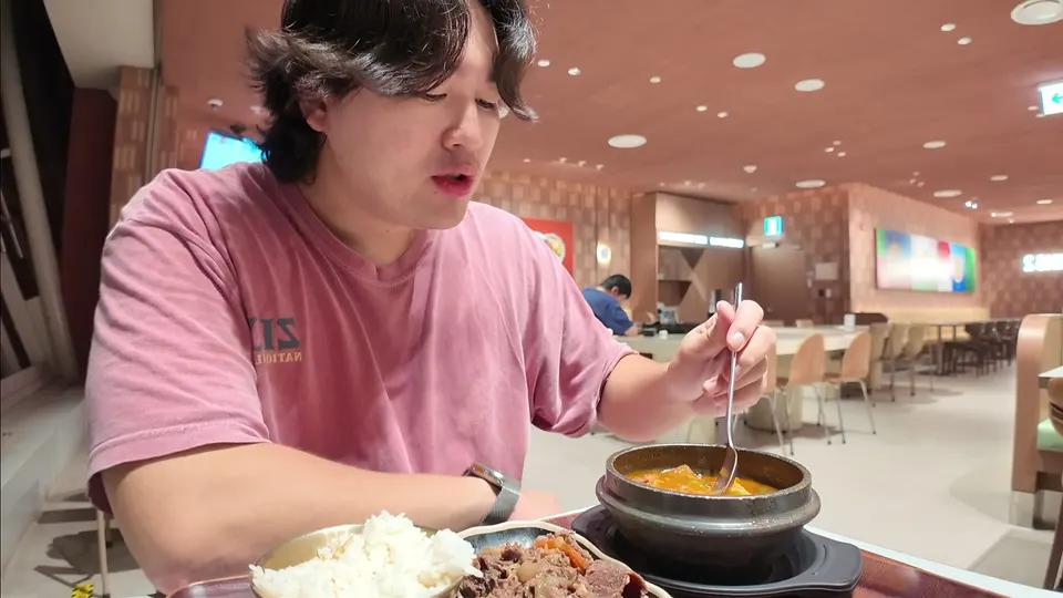Eating rice and a stone pot stew at an empty airport food court