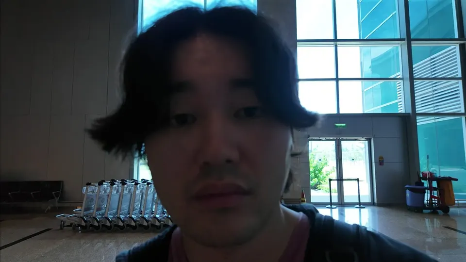 Eddie in the bright arrivals hall at Cam Ranh International Airport with trolleys behind