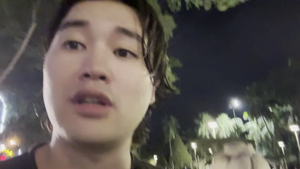 Eddie talking into the chest camera at night under the park trees on the way home