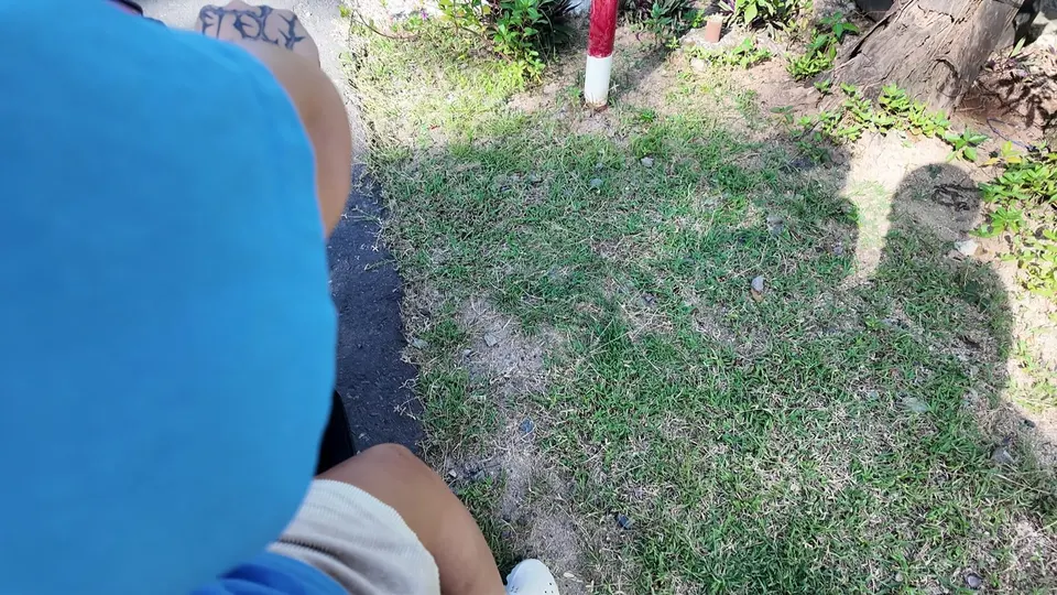 Looking down at grass and a shadow while sitting on the ground